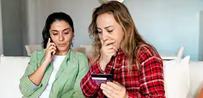 Deux femmes regardant leur écran d'ordinateur l'air inquiet